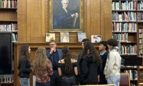 James Butterwick surrounded by students